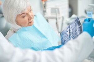 Dentist and patient reviewing X-ray together 